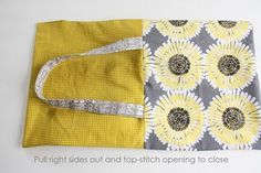 a yellow and gray bag with flowers on it