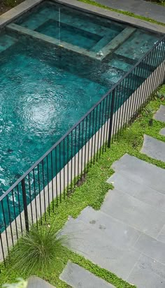 an empty swimming pool in the middle of a yard