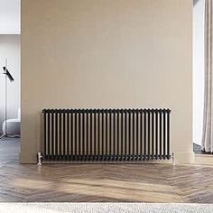 an empty room with a radiator in the middle