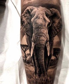 an elephant is shown on the leg and it's head has been painted with black ink