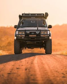 the front end of a four wheel drive vehicle on a dirt road