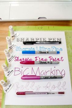 some pens are lined up on top of a piece of paper that says sharpie ultra fine