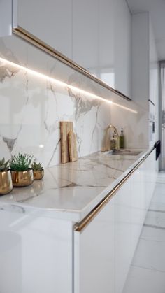 a kitchen with marble counter tops and gold accents