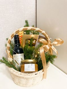 a basket filled with wine, cookies and other items