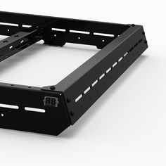 the back side of a black metal rack with two brackets on each side and one arm extended