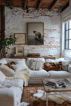 a living room filled with furniture and a brick wall in the background, along with a rug on the floor