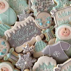 some cookies that are decorated with frosting and snowflakes on top of each other