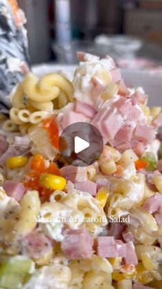 pasta salad with ham and corn in a white bowl