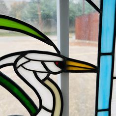 a stained glass window with a bird on it