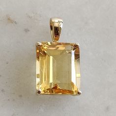 This stunning pendant is set in 14K Solid Yellow Gold with Natural Citrine with utmost precision. It is an unique gemstone pendant for nearly every occasion and is completely hassle-free jewelry. ITEM DETAILS * Gem: Citrine * Gem Size: 10X12mm * Gem Shape: Octagon  * Gem Weight: 5.55 carats * Gold Purity: 14KT  * Gold Weight: 0.99 gram * Total Weight of the Pendant: 2.10 gram The Gold purity is guaranteed and it comes with authentic 14KT gold hallmark. Since my items are handmade, they are absolutely nickel and lead free. CUSTOMIZATION * Gemstone customization is available and it can be substituted with a gem of your choice. Kindly message me for the same. PACKAGING * The Pendant comes with layers of safe and secure wrapping along with Free handmade jewelry box with every purchase. ➡️Head Yellow Gold Gemstone With Accent Stones As Gift, Yellow Gemstones With Accent Stones For Gifts, Citrine Gemstones With Accent Stones For Gift, Yellow Gold Citrine Gemstones For Gift, Octagon Citrine Jewelry For Gifts, Sunny Disposition, Yellow Hues, Handmade Jewelry Box, Citrine Jewelry