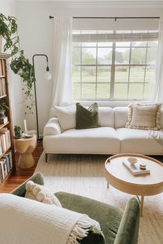 a living room filled with lots of furniture and bookshelves next to a window