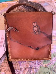 Cute Owl on tree  Brown leather purse. The clasp is a charming key. 8x7 with and 18 inch strap. Beautiful but tough! This hand stitched ( saddle stitch ) has lots of room for rocks if you are a Southwest girl like me . All genuine leather. Happy Trails. This little guy has a blemish on the back left corner so he is priced accordingly Brown Pouch Satchel As Gift, Brown Shoulder Bag With Leather Strap As Gift, Brown Leather Strap Shoulder Bag As Gift, Brown Crossbody Shoulder Bag For Personal Use, Brown Leather Shoulder Bag Gift, Brown Leather Shoulder Bag As Gift, Brown Leather Shoulder Bag For Gift, Brown Leather Satchel As Gift, Brown Shoulder Bag With Leather Backing As Gift