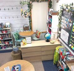 a classroom with desks, chairs and bookshelves filled with children's books