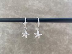 Our Silver Starfish Earrings are made from quality 925 Sterling Silver. The starfish pendants drop from a small hoop earring, and are removable.  These trendy hoop earrings are perfect as Bridesmaid gifts, Birthday Presents, Wedding Day Jewellery. Returns: All earrings must be UNWORN and in original packaging for higiene purposes, otherwise the return will not be processed.  Feel free to message with any questions :) Wedding Day Jewelry, Starfish Earrings, Starfish Pendant, Beach Jewelry, Silver Hoops, Huggies Earrings, Starfish, Bridesmaid Gifts, Jewelry Earrings Dangle