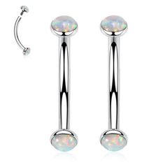 pair of surgical steel belly ring with opal balls on each side and an attached barbell