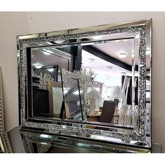 a large mirror sitting on top of a table