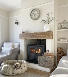 a living room filled with furniture and a fire place next to a wall mounted clock