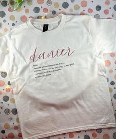 The perfect gift for the dancer in your life, this t-shirt features all words in heat transfer vinyl (dancer in pink glitter vinyl and the definition in black vinyl). It makes the perfect back to school, dance recital, or competition gift for your young (or not so young) dancer!  Each shirt was designed by my daughter. She also helps tie dye any dyed shirt, to help earn money for her dance classes. Shirts will be made to order and could be a little bit different than pictured. We use Gilden Cotton shirts that run true to size. For children, size X-Small is 4/5, Small is 6/8, Medium is 10, Large 12, X-Large 14/16. For tie dye colors, we rinse out with water and free & clear sensitive skin laundry detergent after dying with fiber reactive dyes. ✨Please message us if you would like different Pink Letter Print T-shirt For Dance Class, Pink T-shirt With Graphic Print For Dance Class, Pink Graphic Print T-shirt For Dance Class, Dance Definition, Dance Shirt, Dance Classes, The Dancer, Dance Shirts, Tie Dye Colors