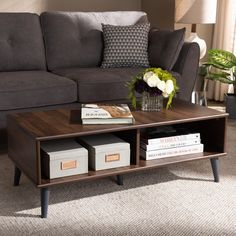 a living room with a couch, coffee table and two lamps on the side tables