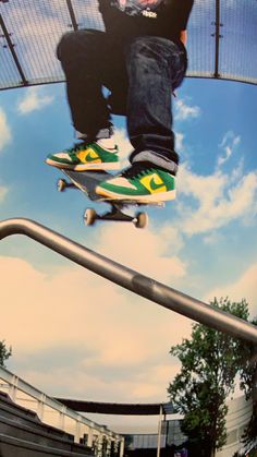 a man flying through the air while riding a skateboard on top of a rail