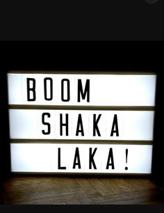 the words boom, shaka, laka are lit up in black and white