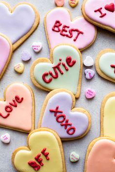 decorated cookies with the words best cutie in different colors and shapes on a table