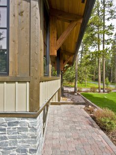 the front porch of a house with brick walkway