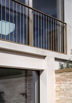 an open garage door on the side of a building with a window and balcony above it