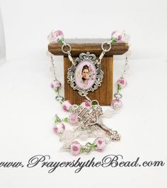 Chaplet of St Therese Little Flower of Jesus, wire wrapped into a seamless display of gems, lampwork glass and custom created rosary pieces hand crafted by religious hands exclusively for this ministry shop, Prayers by The Bead.   A lovely custom colored  enameled pink crucifix begins this chaplet.  Faceted rose quartz and silver foil Rose Lampwork begins the prayer journey, silver tone twist connector links completes this circle of prayer. This chaplet of 25 beads has both gemstones and artisan Spiritual Wire Wrapped Rosary As Gift, Handmade Adjustable Rosary For First Communion, Spiritual Gift Wire Wrapped Rosary, Rose Quartz Rosary, Pink Healing Rosary With 8mm Beads, Pink Spiritual Hand-strung Rosary Bracelet, Pink Cross-shaped Rosary Bracelet Gift, Spiritual Hand-wrapped Rose Quartz Necklace, St Therese