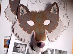 an animal mask made out of paper on top of a piece of paper with pictures