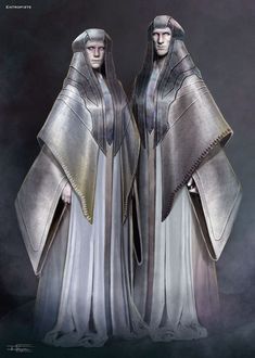 two women dressed in silver and gold standing next to each other on a dark background