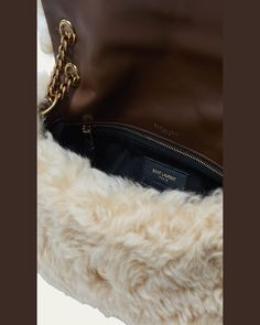 Saint Laurent "Calypso" shoulder bag in leather and natural/dyed sheep shearling (Italy)    Features signature YSL logo lettering    Sliding chain shoulder strap can be doubled    Envelope flap top with magnetic closure  Bronze hardware.   Interior, one zip pocket    Approx. 4.9"H x 7.9"W x 2"D   Made in Italy Luxury Shoulder Bag With Faux Fur Lining, Luxury Sheepskin Bags With Faux Fur Lining, Luxury Leather Shoulder Bag With Faux Fur Lining, Ysl Shoulder Bag, Travel Size Perfume, Ysl Logo, Bronze Hardware, Cleanser And Toner, Chain Shoulder Bag