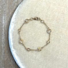 Add sophisticated sparkle to your outfit with this delicate beaded bracelet. Hand crafted from Swarovski crystal beads, the pale champagne hue catches the light as you move, adding a touch of glamour to any occasion. Whether it's a casual outing, a romantic date night, a cocktail party, a wedding celebration, or a memorable prom, this bracelet is your perfect accessory. Key Features: * Swarovski Golden Shadow Crystal: Enchanting champagne tone is the perfect finishing touch. * Gold Filled Hardware: Classic and timeless, perfect for any occasion. * Lobster Clasp Closures:  Secure and comfortable for all-day wear. * 7.25 Inch Length: Check measurements for a perfect fit. * Sueded Jewelry Pouch: Your bracelet comes nestled in a luxurious pouch, ready for gifting or safekeeping. * Handmade in Gold Bridal Jewelry, Length Check, Romantic Date Night, Golden Shadow, Swarovski Crystal Bracelet, Romantic Date, Swarovski Crystal Beads, Crystal Beads Bracelet, Bridal Gold Jewellery