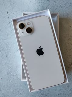 an apple iphone 11 in its box on the ground with it's lid open