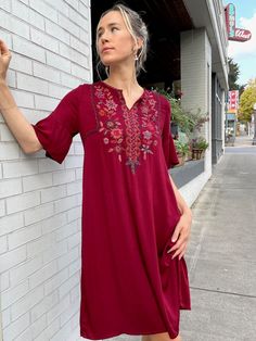 "Handcrafted in a sumptuous silky rayon, the Josefina dress features an easy slip on fit with princess seams in the bodice, ample width in the hip, petal bell sleeve, and rich hand embroidered details on the front and neck. Designed longer, by customer request, the center back length is 39\" for size S. Pre-washed, machine washable. Fair trade verified. Model is 5'9 size S. *Embroidery may vary slightly due to the handcrafted nature of the garment." Flowy V-neck Embroidered Dress, Short Sleeve Viscose Bohemian Dress, Flowy Floral Embroidered Dress, Flowy Embroidered Dress With Floral Details, Bohemian Midi Dress With Floral Embroidery, Bohemian Midi Dress With Floral Embroidery And Short Sleeves, Flowy Embroidered Dress With Floral Design And Short Sleeves, Flowy Embroidered Dress With Floral Detail And Short Sleeves, Flowy Floral Embroidered Dress With Short Sleeves