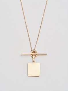 The must-have layer. Crafted from reclaimed 14Kt gold that’s gone through a refining process, the toggle necklace with its unique square ID tag simple yet striking. Style it with chains of different girths and length for a lustrous layered look. 14Kt Yellow Gold ID and Toggle Necklace ID Tag: 12 X 13.5mm Chain: 0.5mm Toggle Closure: 15mm Available in 16” or 18” Lengths Assembled in L.A. Globally Sourced Materials Square Tag Necklace, Quadrafoil Necklace, Toggle Necklace, Shiny Things, Recycled Gold, Pure Gold, Id Tag, Layered Look, Gold Hoop