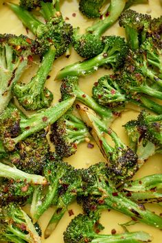 broccoli florets are being cooked in a pan with mustard and seasoning