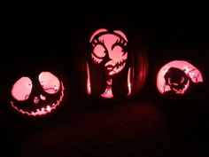 three pumpkins with faces carved into them