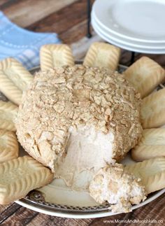 a white plate topped with cookies covered in frosting on top of a wooden table