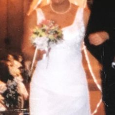 a bride and groom walking down the aisle