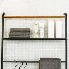 a shelf that has some towels and other items on it