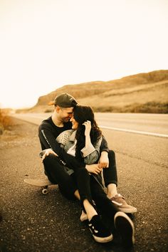 a man and woman are sitting on the road