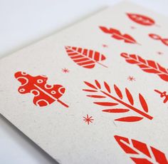 red and white paper with leaves on it