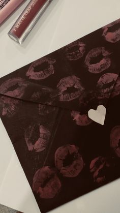 an envelope with hearts and lipstick on it