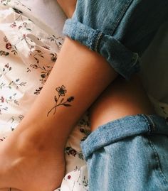 a woman's arm with a flower tattoo on the left side of her body