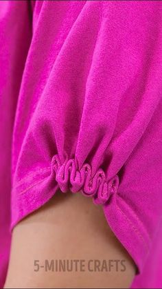 the back of a woman's pink shirt with ruffles