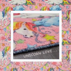 the unicorn love rug is on display in front of a pink background