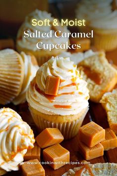 some cupcakes are sitting on a table with frosting and orange icing