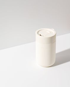 a white cup sitting on top of a table