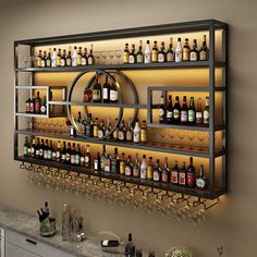 a wall mounted shelf filled with lots of bottles and glasses on top of a counter